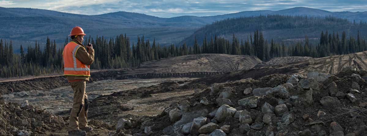 Mining Site Image of mining site with worker overlooking the area