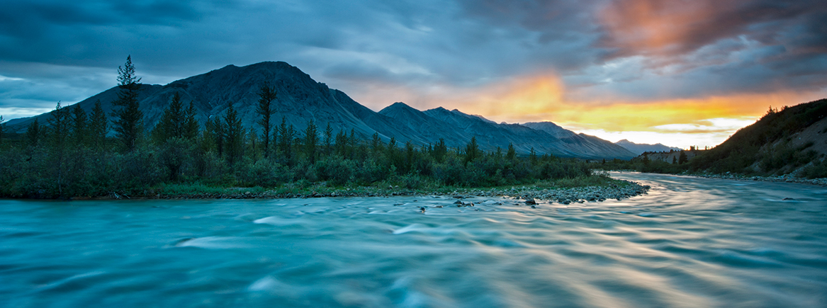 River Scene Image pf a remote wilderness river with mountain in the background